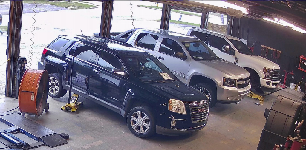 Customer trucks and SUV lined up in Izzy's Tires service bay