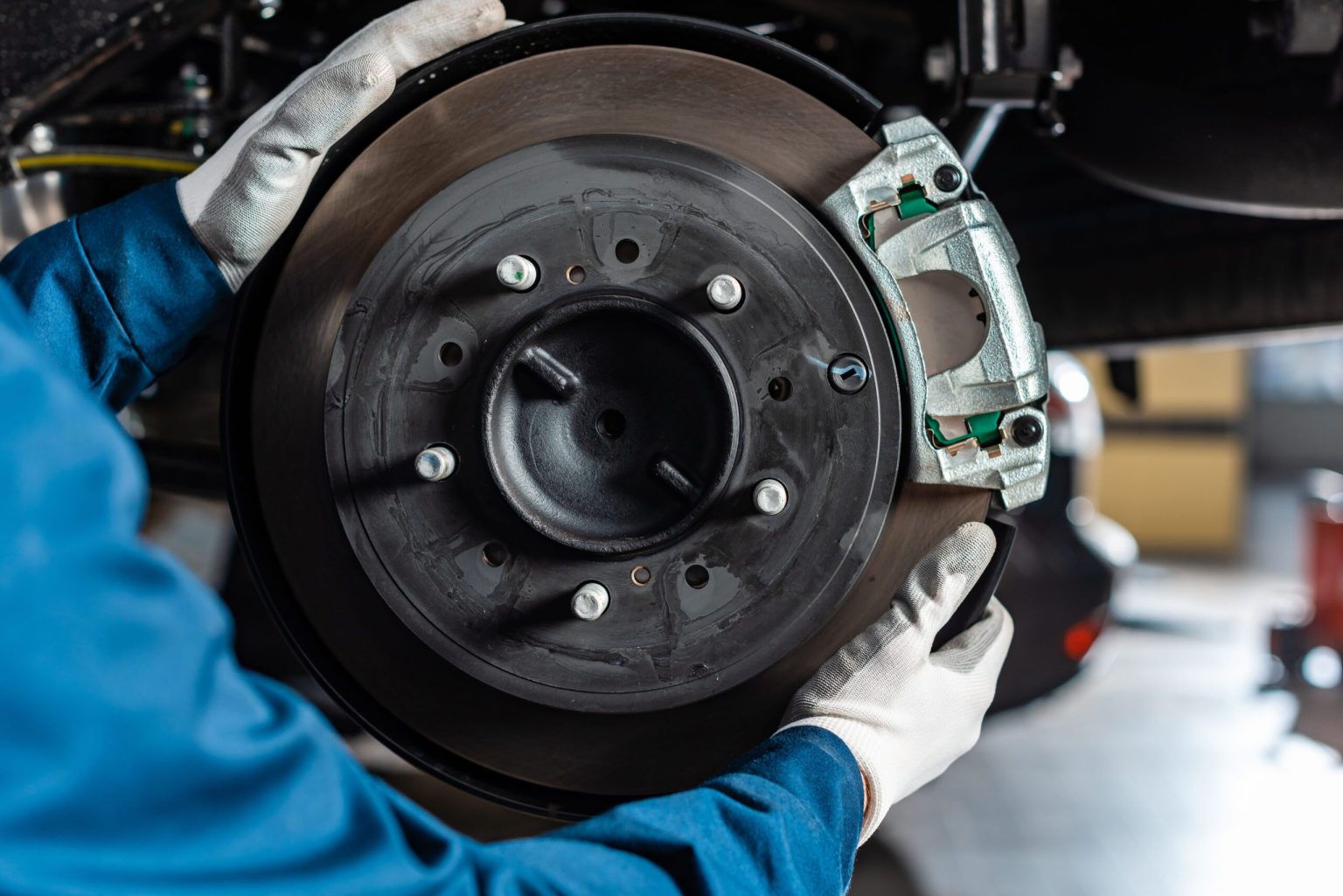 Izzy's technician performing a brake rotor and caliper service