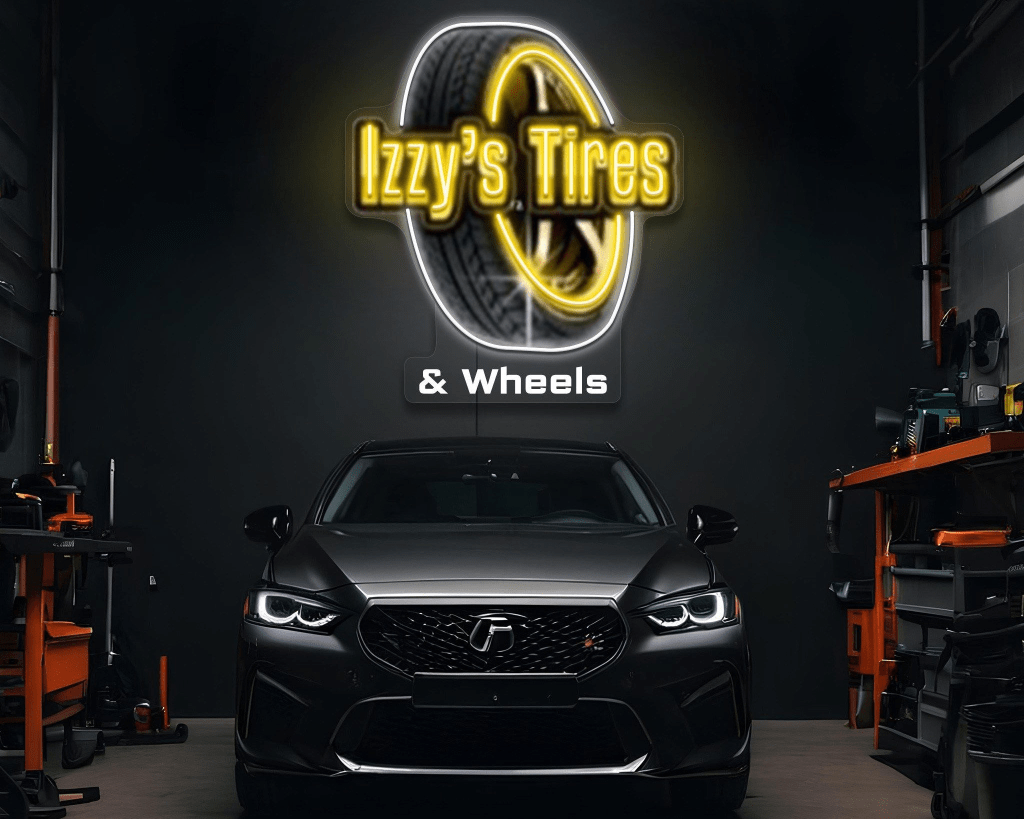 Izzy's Tires & Wheels neon sign glowing above a customer vehicle in the shop